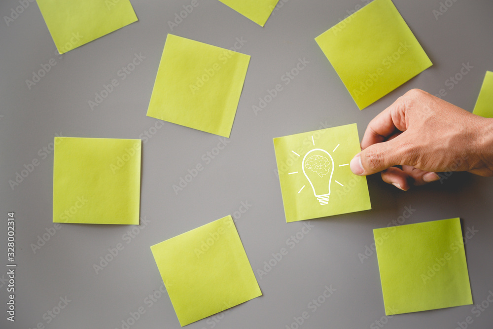 Business using sticky note lightbulb drawing on post it notes