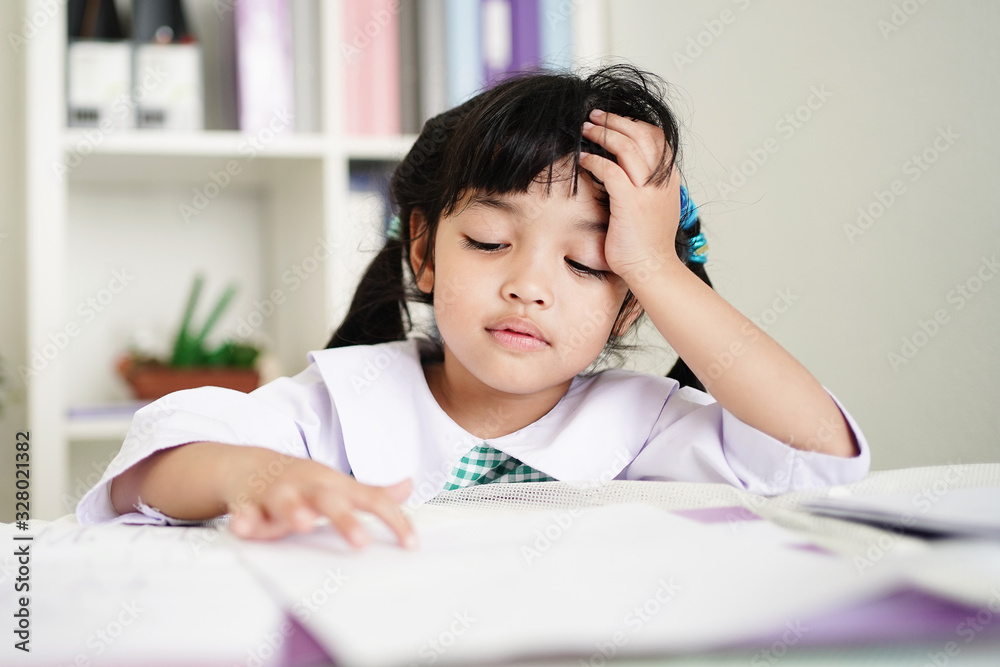 Little child girl concentrate and focusing to the homework for elementary school. thinking seriously