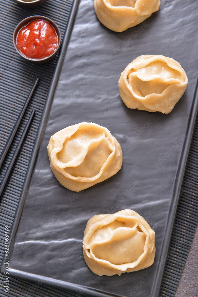 Plate with oriental dumplings on table