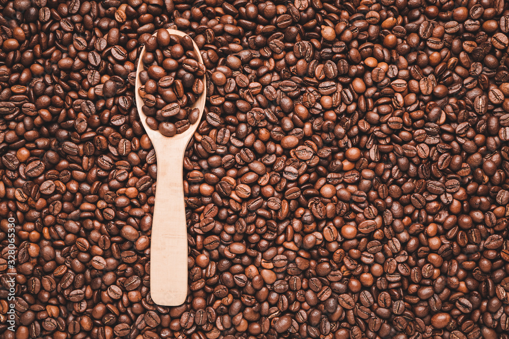 Spoon on roasted coffee beans