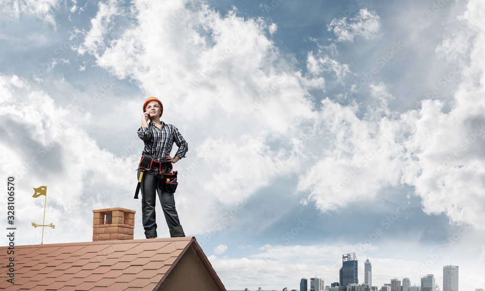 Attractive woman in workwear and hardhat