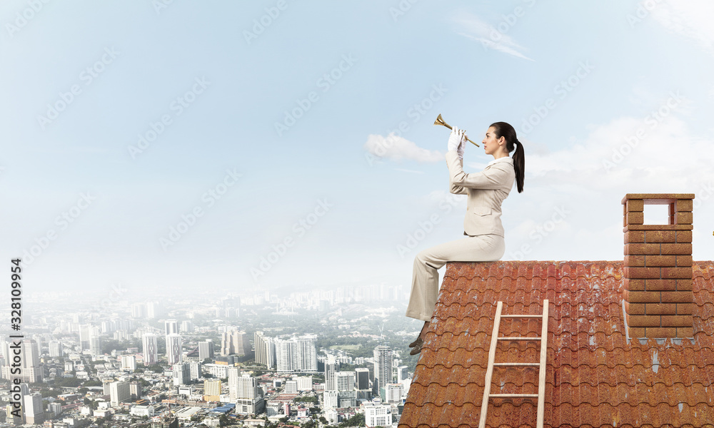 Young woman playing trumpet and sitting on roof