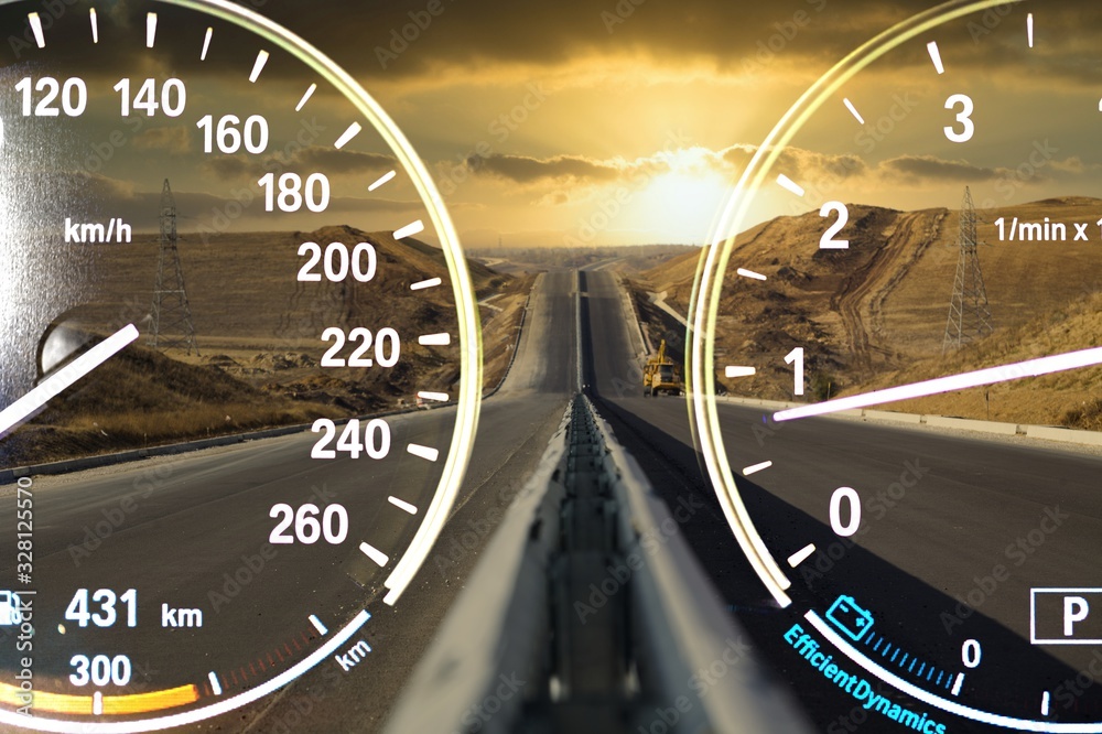 Speedometers on road background with blue cloudy sky