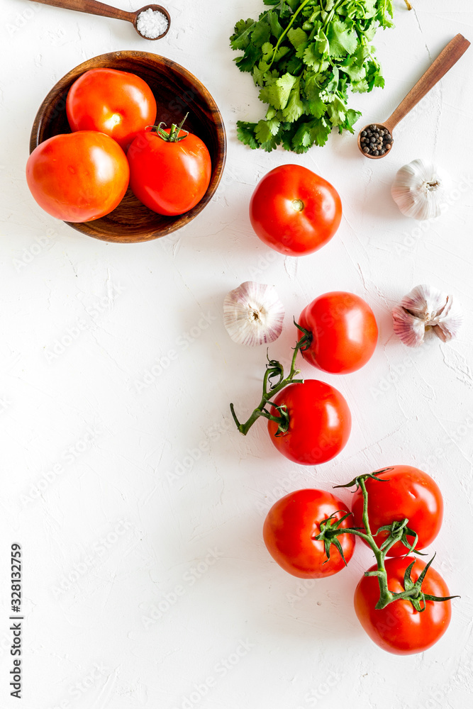 Tomatoes for preserves. Vegetables near garlic, greenery and spices on white background top-down cop