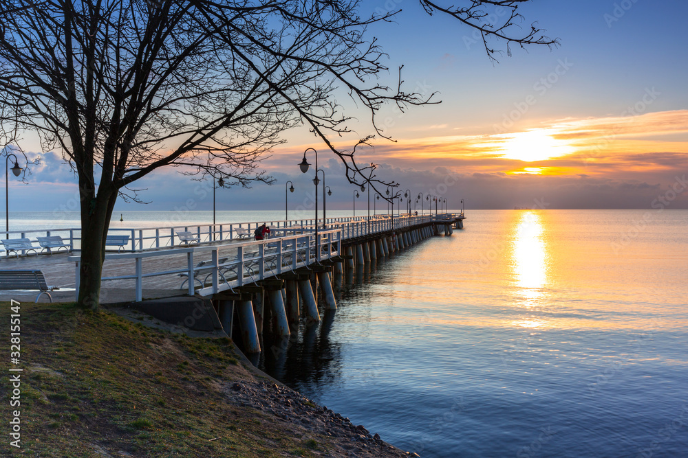 Beautiful landscape with wooden pier in Gdynia Orlowo at sunrise, Poland