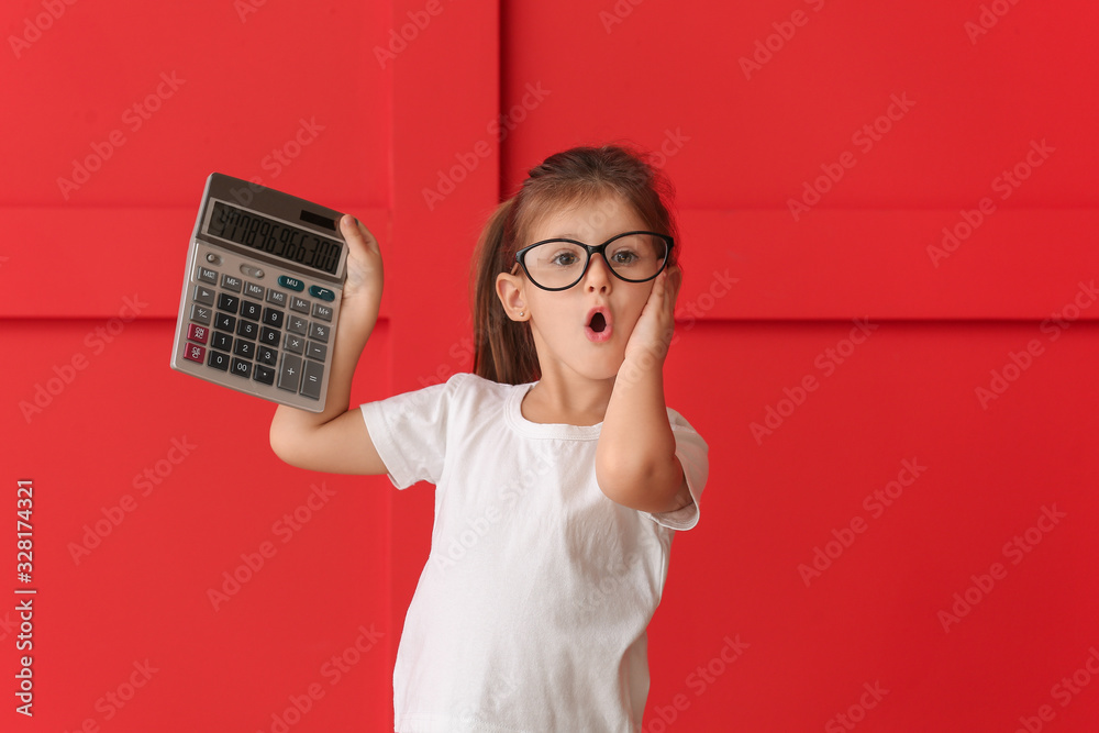 Funny surprised little girl with calculator on color background