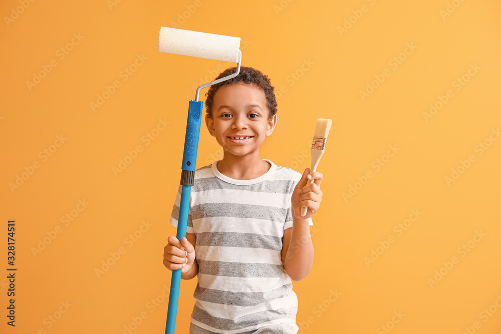 Little African-American painter on color background