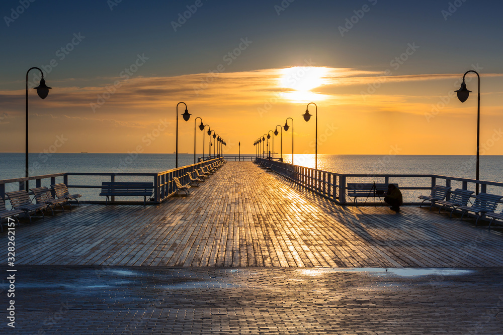 Beautiful landscape with wooden pier in Gdynia Orlowo at sunrise, Poland