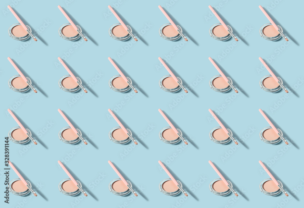 Set of decorative cosmetics with brushes on color background