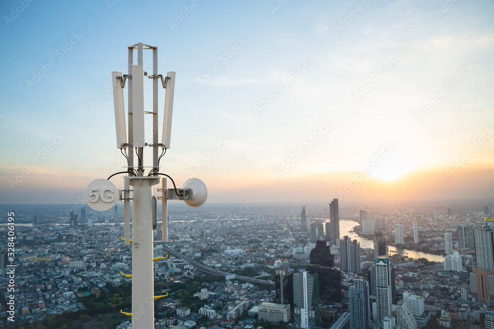 Telecommunication tower with 5G cellular network antenna on city background