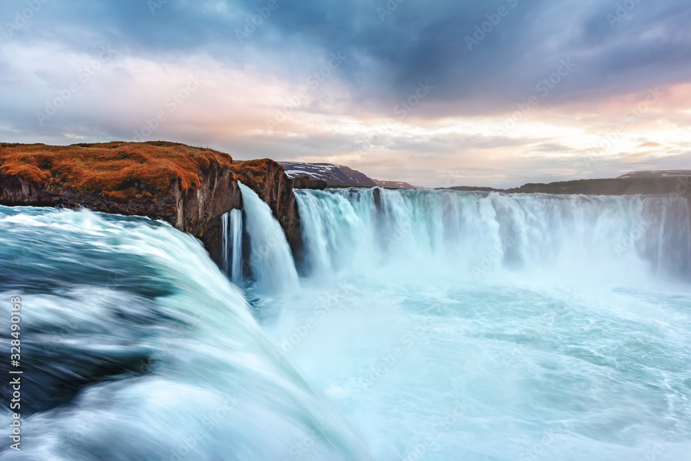 Picturesque landscape with colorful sunrise on Godafoss waterfall on Skjalfandafljot river, Iceland