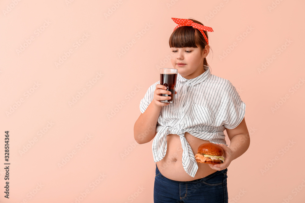 超重女孩用不健康的汉堡和彩色背景饮料