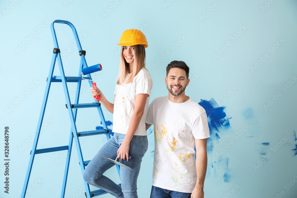 Happy young couple doing repair in their new house