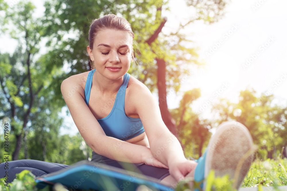 Beautiful smiling girl stretching before fitness