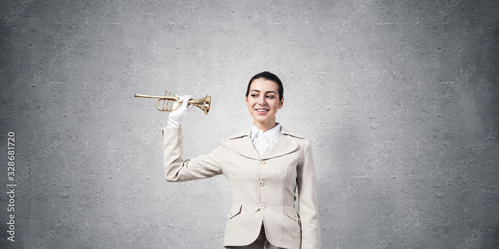 Beautiful woman holding trumpet brass near ear