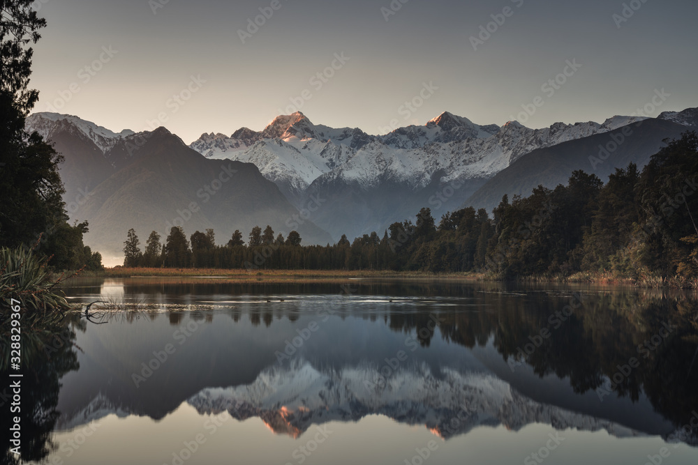 Sunrise at lake Matheson with reflection of mount Cook and mount Tasman, Fox glacier, South island, 