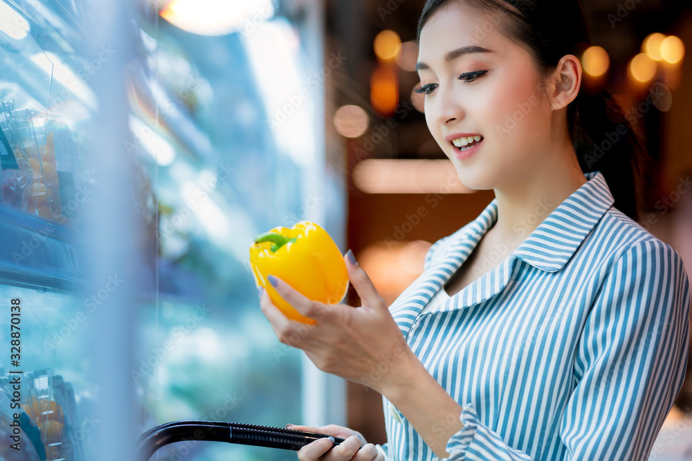 asian attractive female shopping with happiness and cheerful on supermarket blur mall bokeh backgrou