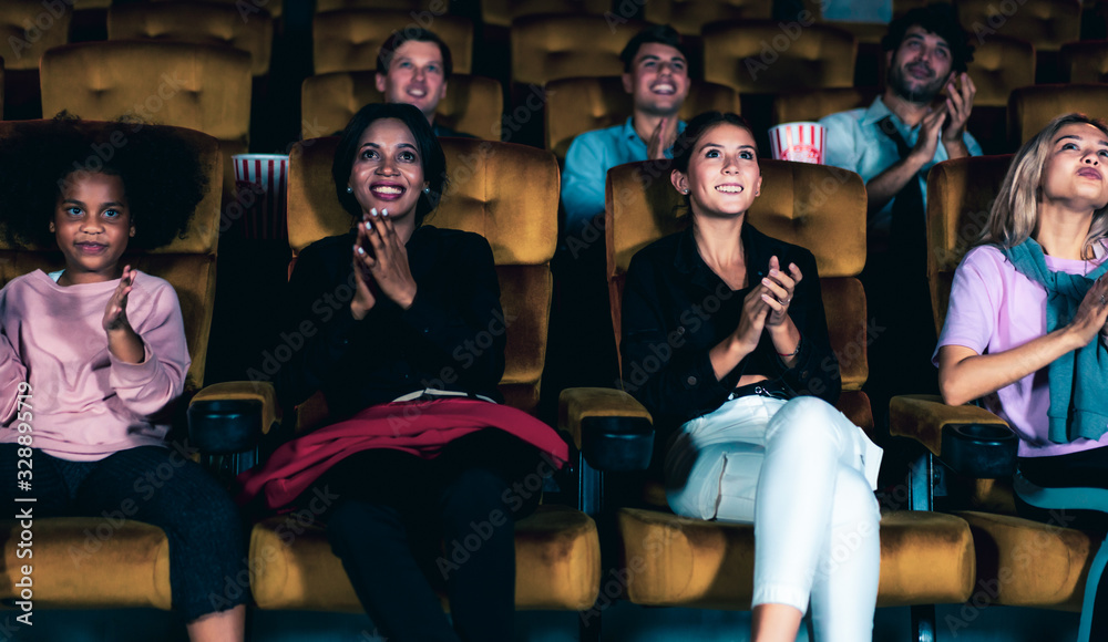 People audience watching movie in the movie theater cinema. Group recreation activity and entertainm