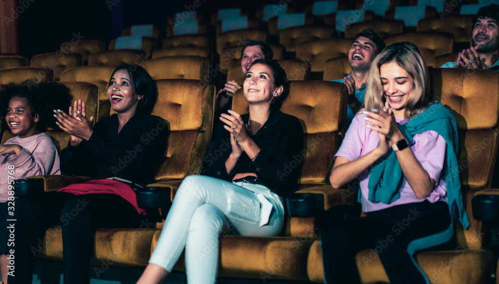 People audience watching movie in the movie theater cinema. Group recreation activity and entertainm