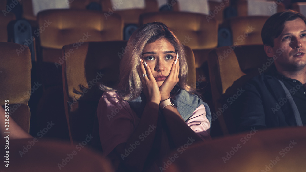 People audience watching movie in the movie theater cinema. Group recreation activity and entertainm