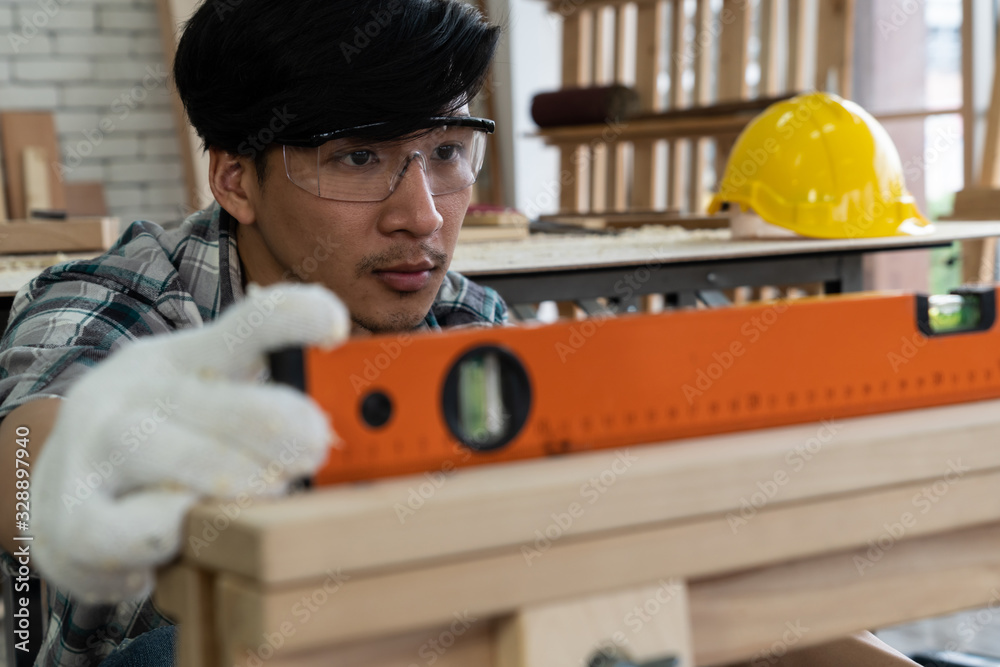 Carpenter working on wood craft at workshop to produce construction material or wooden furniture. Th