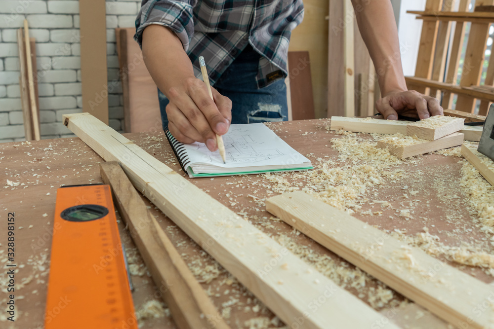 Carpenter working on wood craft at workshop to produce construction material or wooden furniture. Th