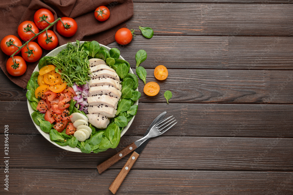 Bowl with tasty salad on wooden background