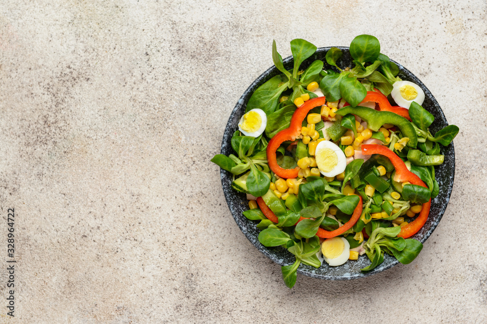 Bowl with tasty salad on grey background