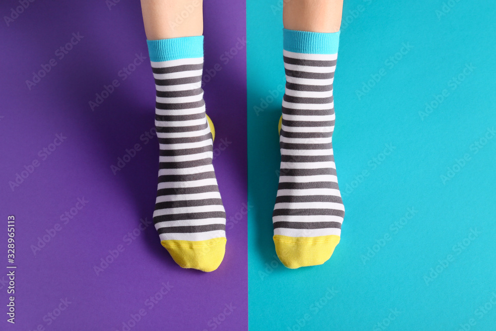 Legs of woman in socks on color background