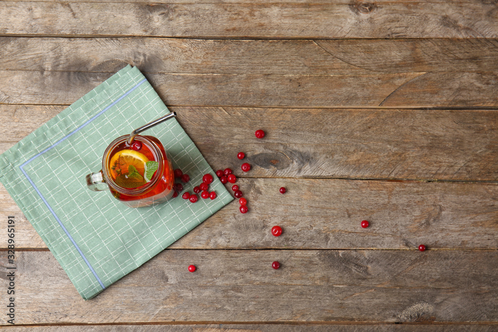 Mason jar of cold tea on wooden table