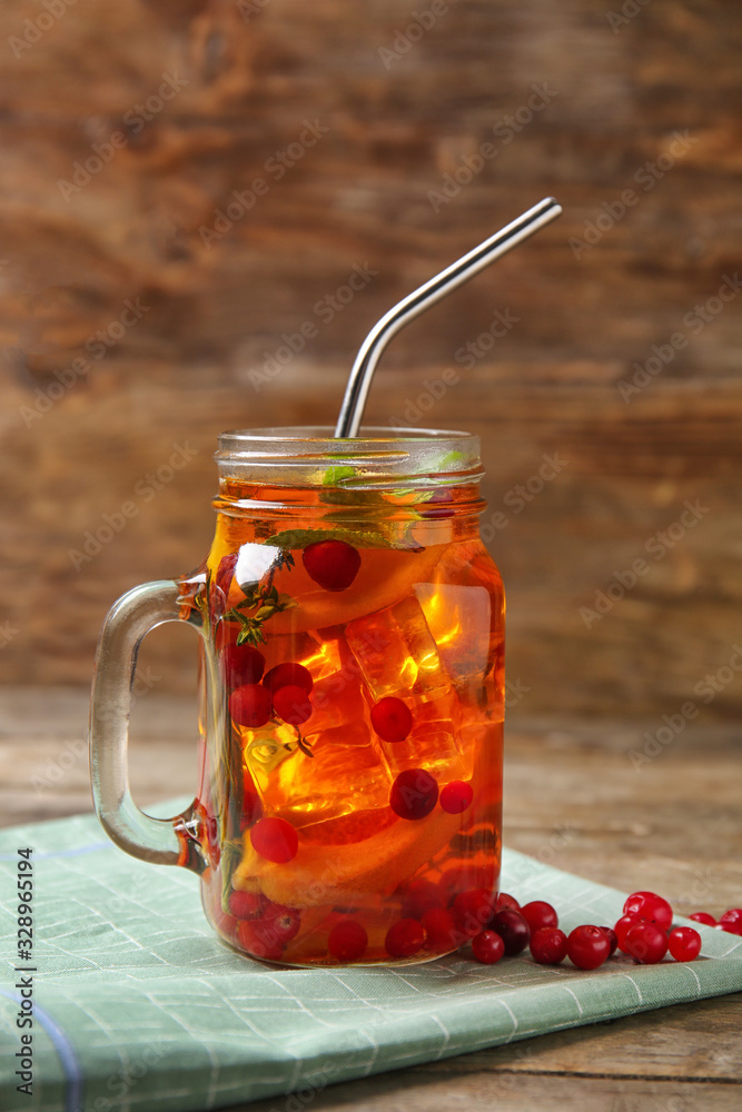 Mason jar of cold tea on wooden table