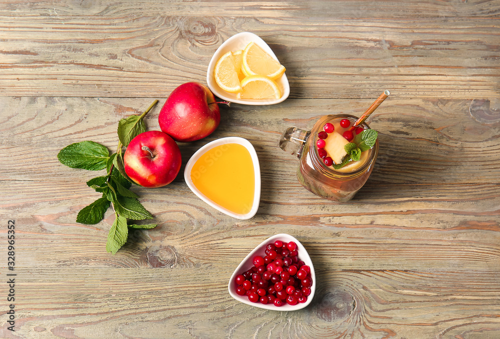 Mason jar of cold tea and ingredients on wooden table