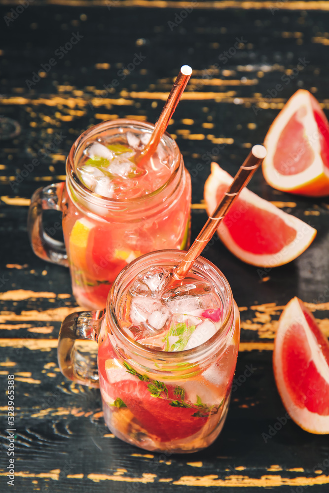 Mason jars of cold tea on dark wooden table