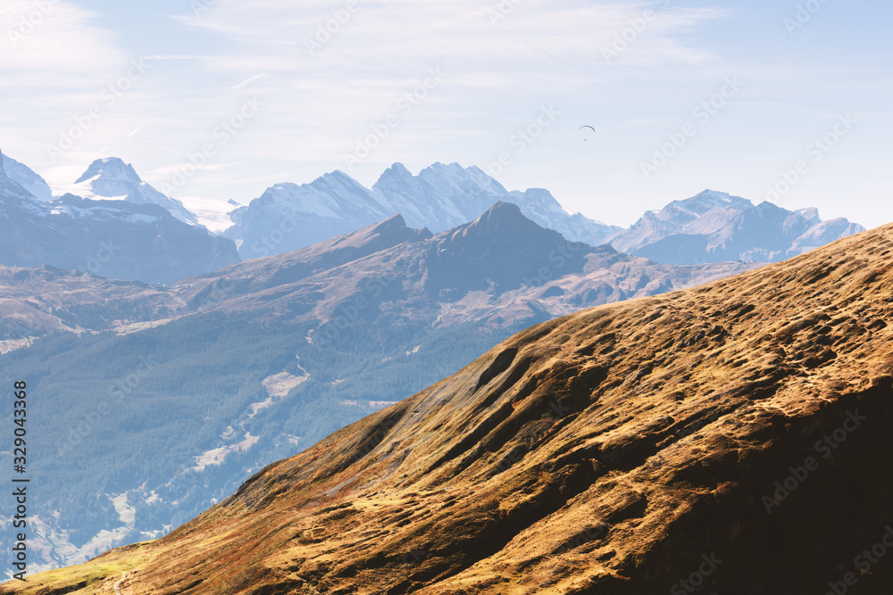 Picturesque autumn landscape with mountains range in Grindelwald village in Swiss Alps