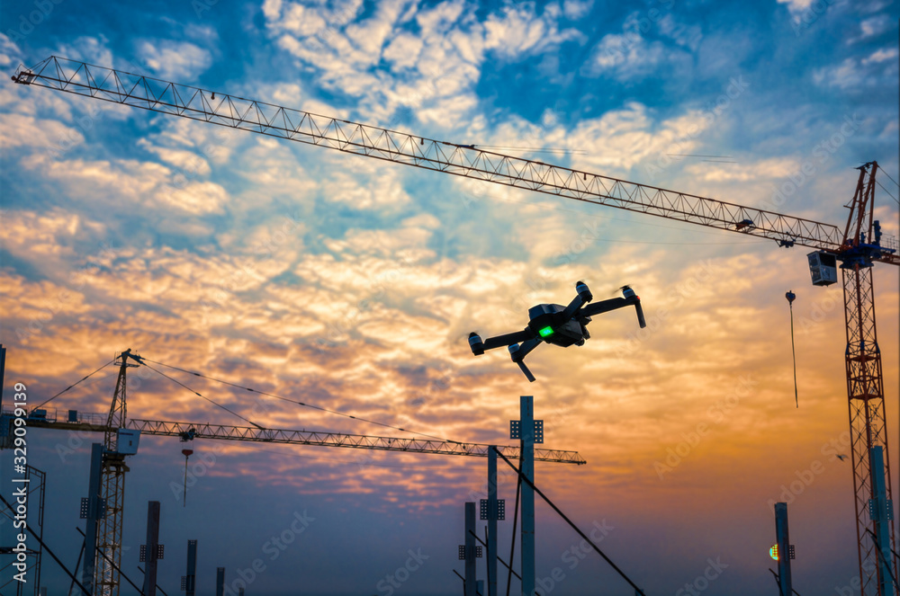 Drone over construction site. video surveillance or industrial inspection