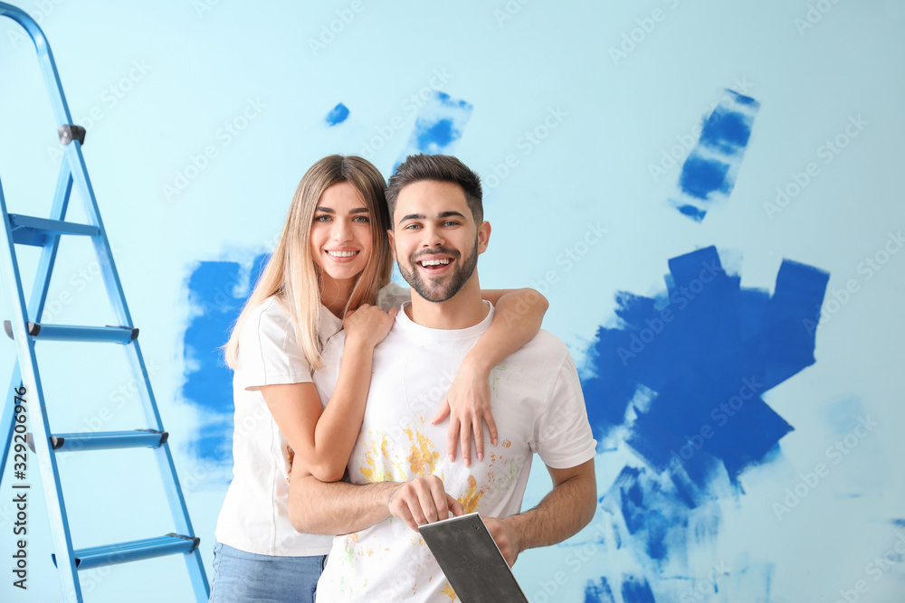 Happy young couple doing repair in their new house