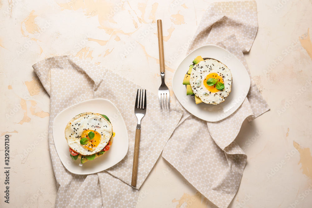 Sandwiches with fried eggs on white background