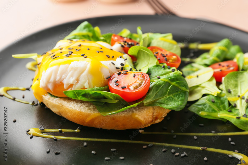 Tasty egg Benedict on plate, closeup