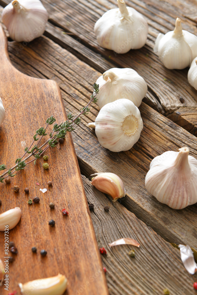 Fresh garlic with spices on wooden table