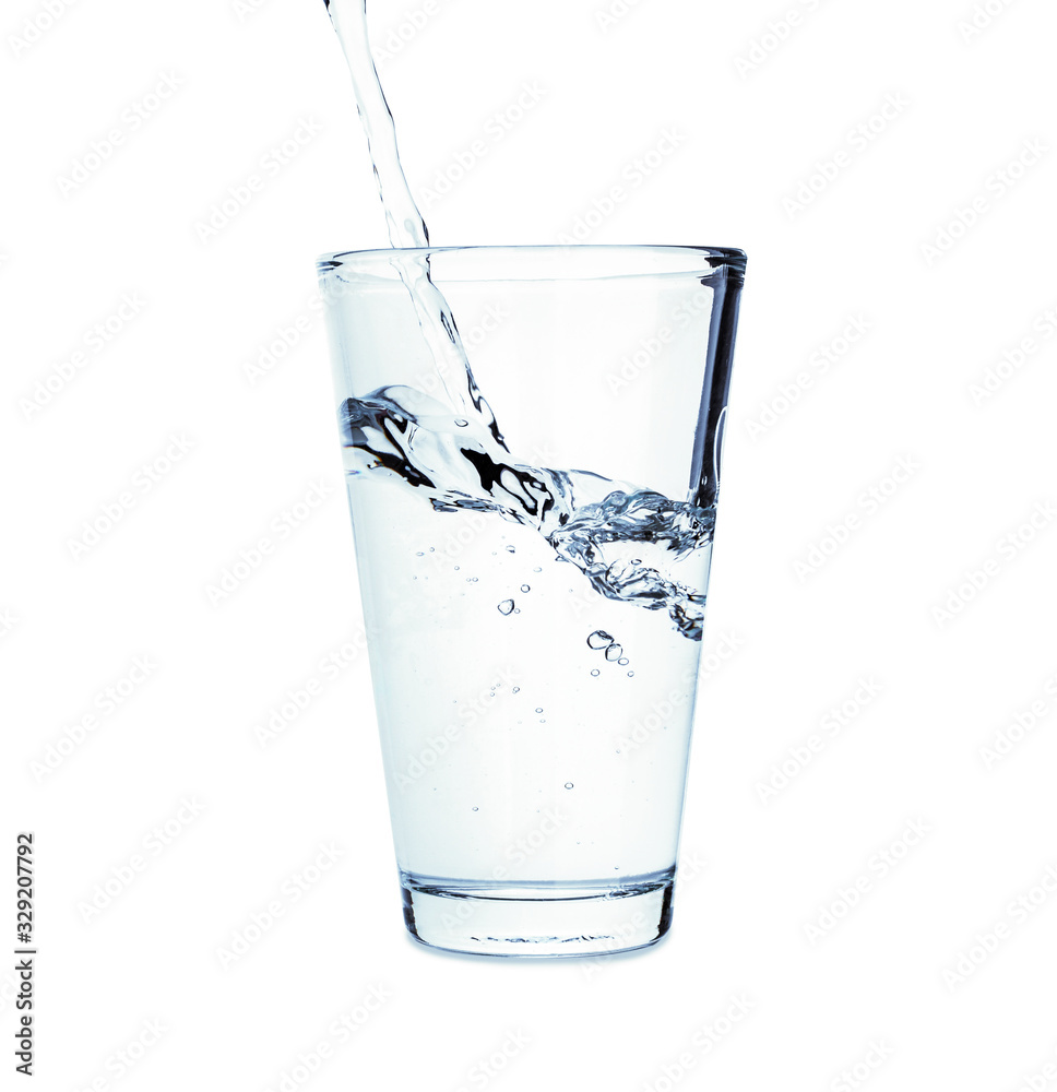 Pouring of fresh water in glass on white background