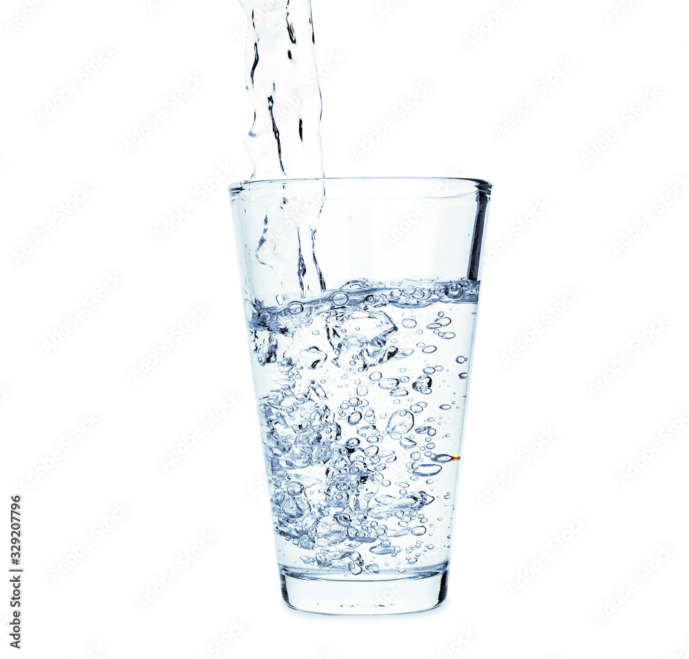 Pouring of fresh water in glass on white background