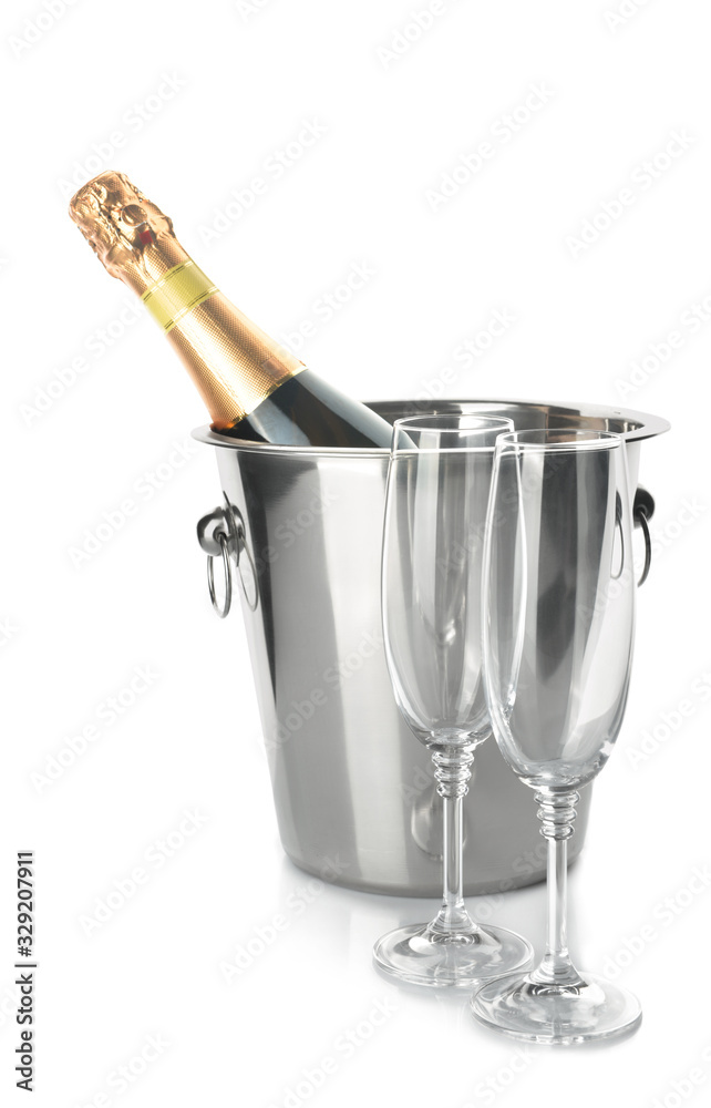 Bucket with bottle of champagne and glasses on white background