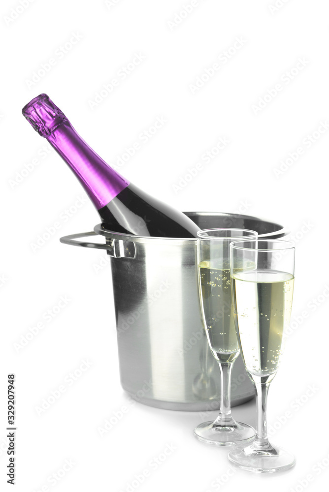 Bucket with bottle and glasses of champagne on white background