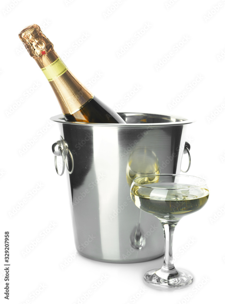 Bucket with bottle and glass of champagne on white background