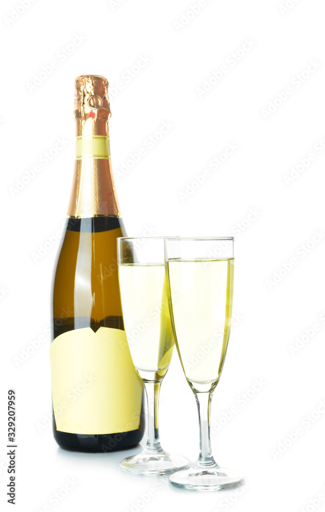 Bottle and glasses of tasty champagne on white background