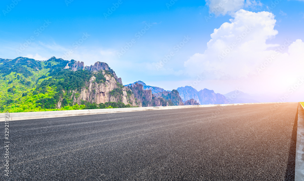 Empty asphalt road and green mountain with beautiful clouds,panoramic view.