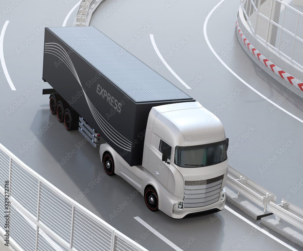 Generic design Heavy Electric Truck passing highway curve. The cargo container equipped with solar p