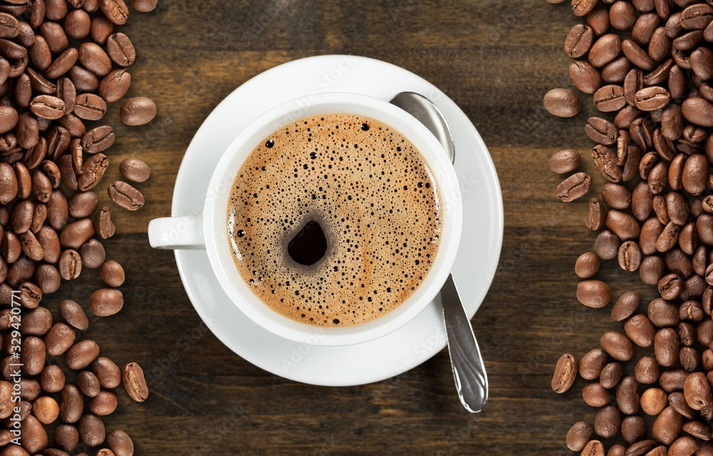 Aroma coffee cup and coffee beans on wooden desk