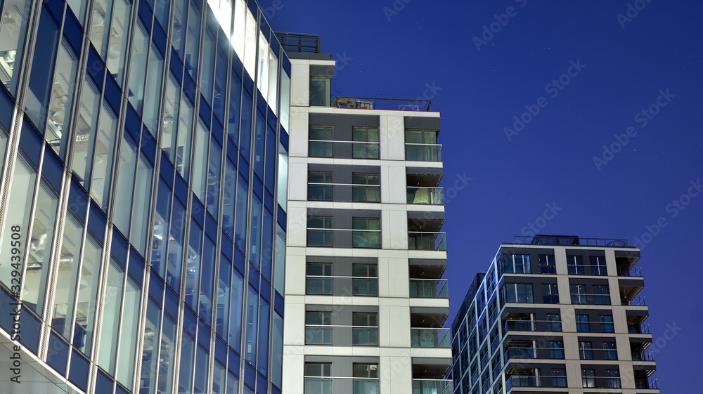 Pattern of office buildings windows illuminated at night. Lighting with Glass architecture facade de