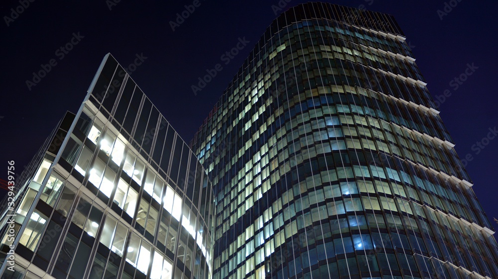 Pattern of office buildings windows illuminated at night. Lighting with Glass architecture facade de